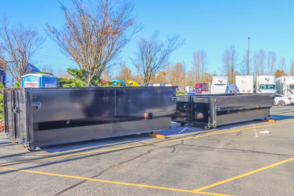 Professional dumpster rental service with roll-off container on residential driveway in Oberlin